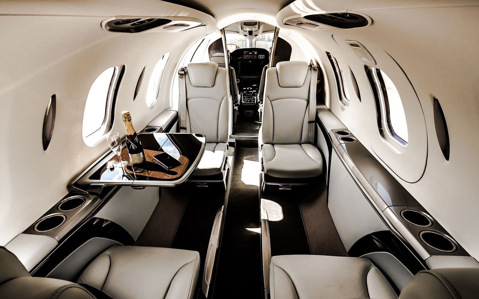 Private jet cabin with cream leather seats