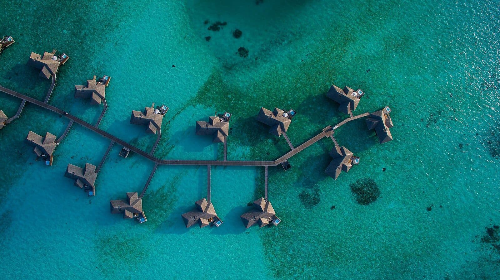 Overwater villas above a turquoise Maldivian lagoon