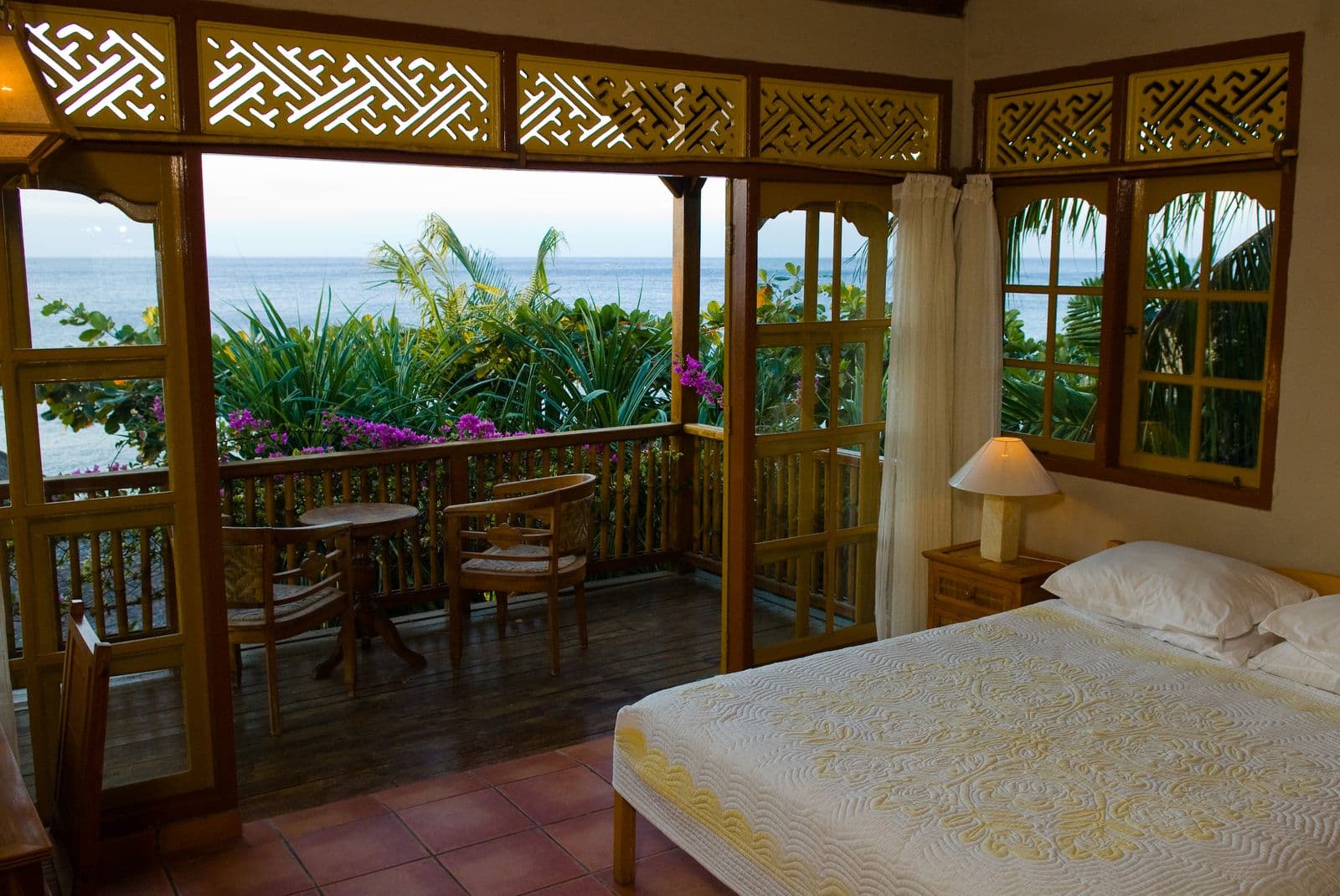 Villa bedroom opening onto the ocean