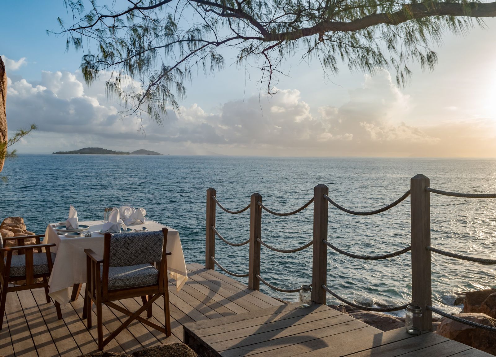 Dinner table set beside the sea