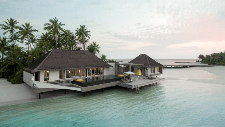 Overwater villa with a pool deck on a calm lagoon