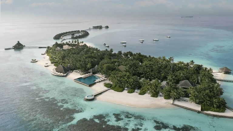 Small island resort ringed by reef, seen from the air