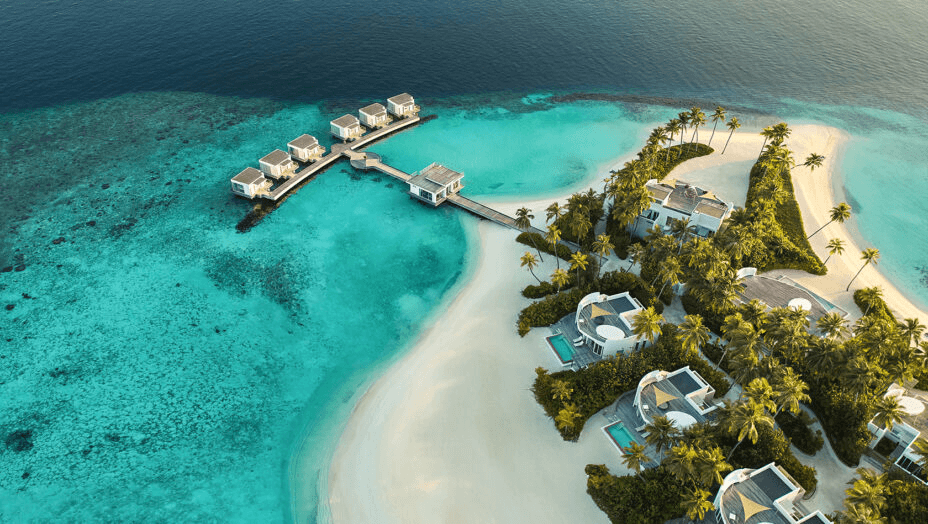 Island villas and a sandbank curving into a turquoise lagoon