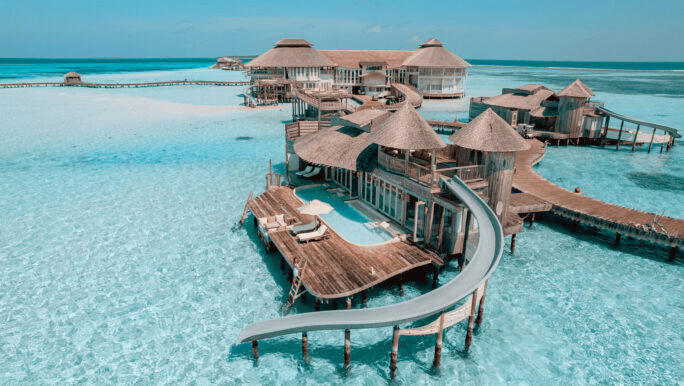 Overwater villa with a water slide into the lagoon