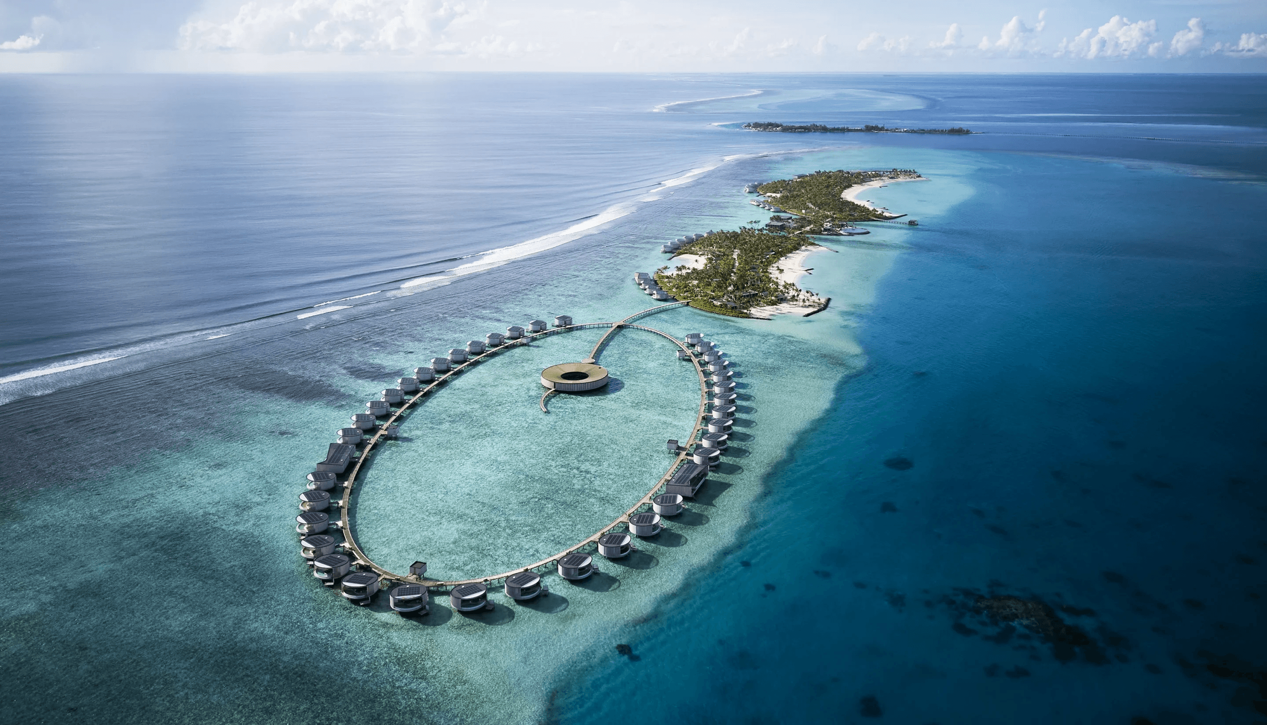 Ring of overwater villas in a lagoon, seen from the air