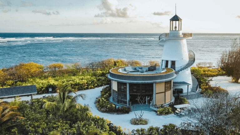Lighthouse beside a round pavilion by the sea