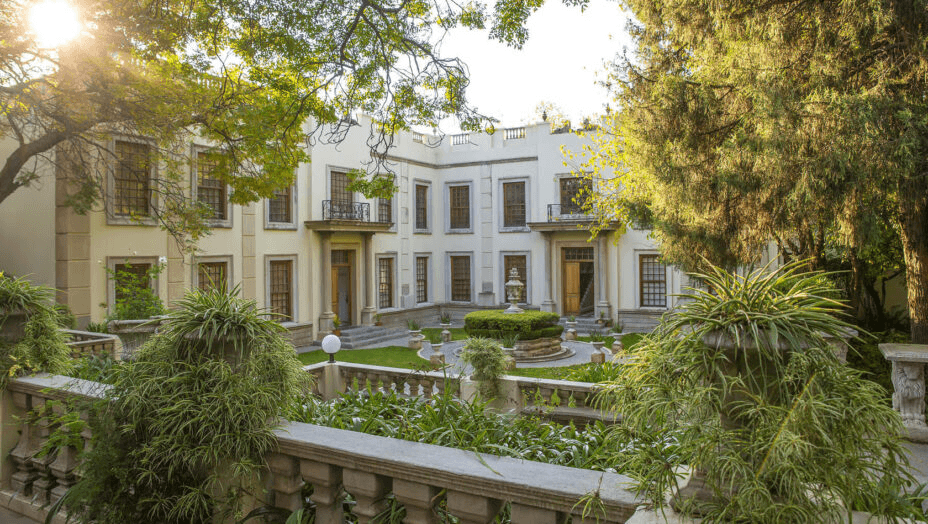 Colonial-style manor behind a formal garden