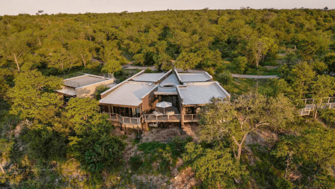Thatched lodge in dense bush, seen from the air