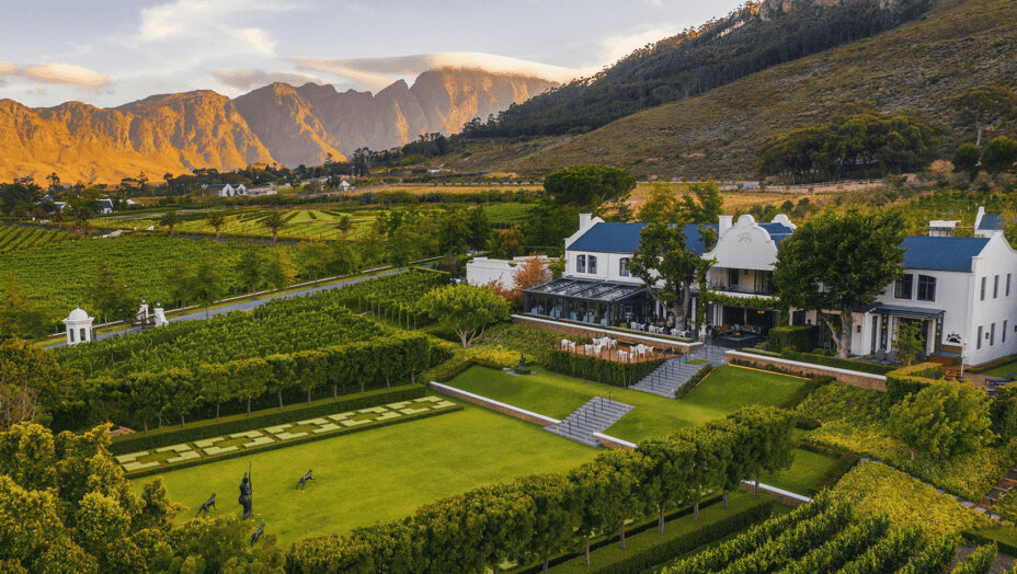 Manor houses above terraced gardens and mountains
