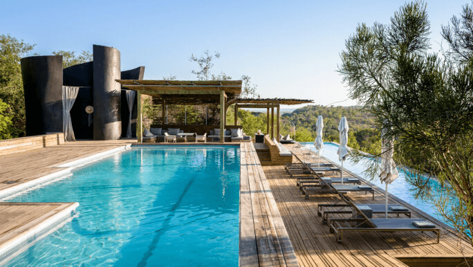 Lap pool and deck on a cliff above the bush