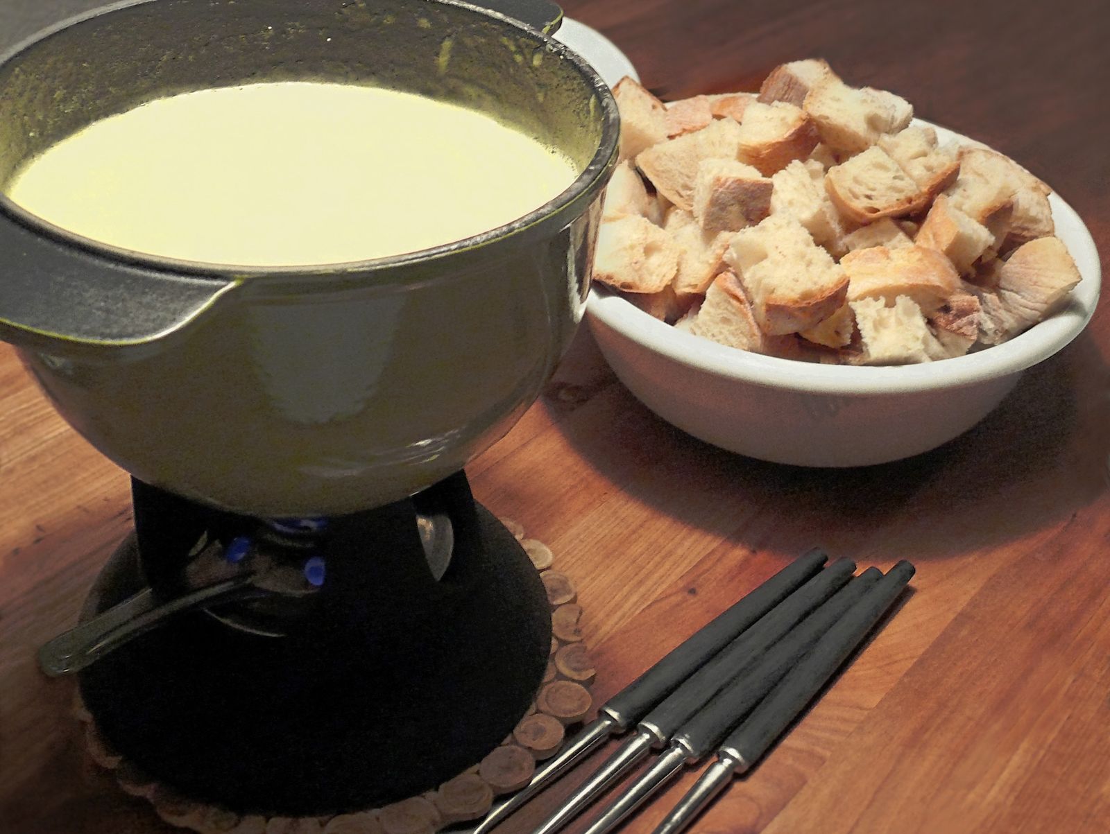 Alpine dinner table set with fondue and local specialities