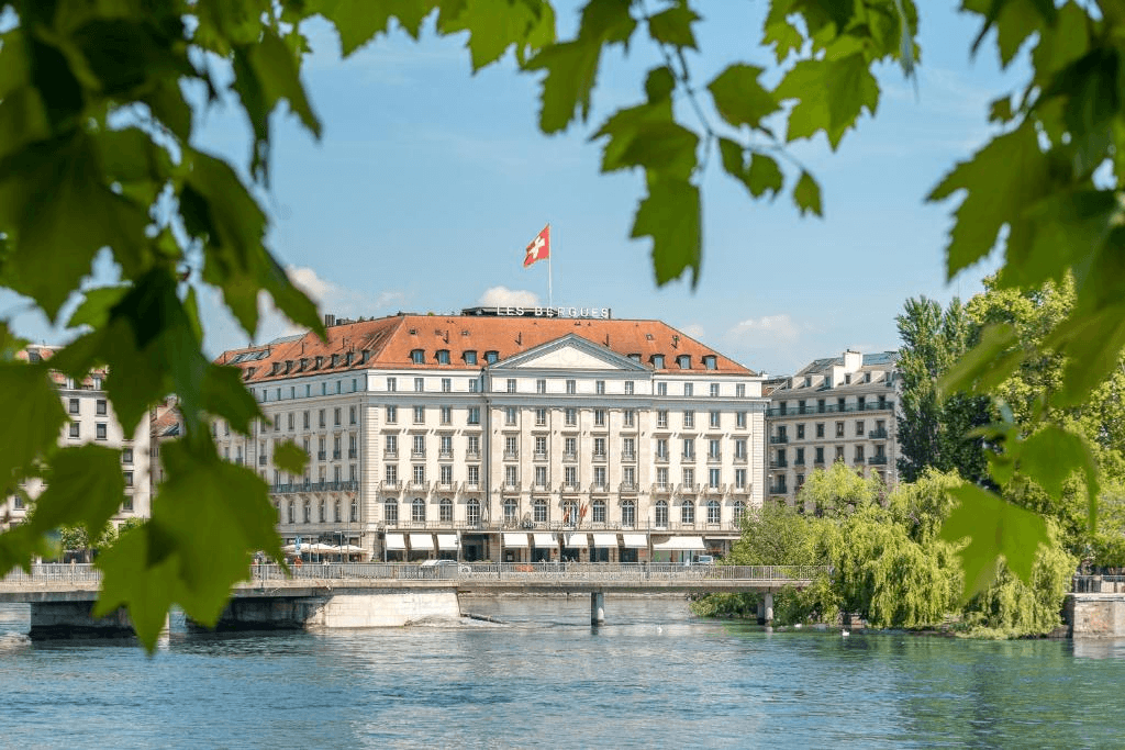 Grand lakeside hotel framed by leaves