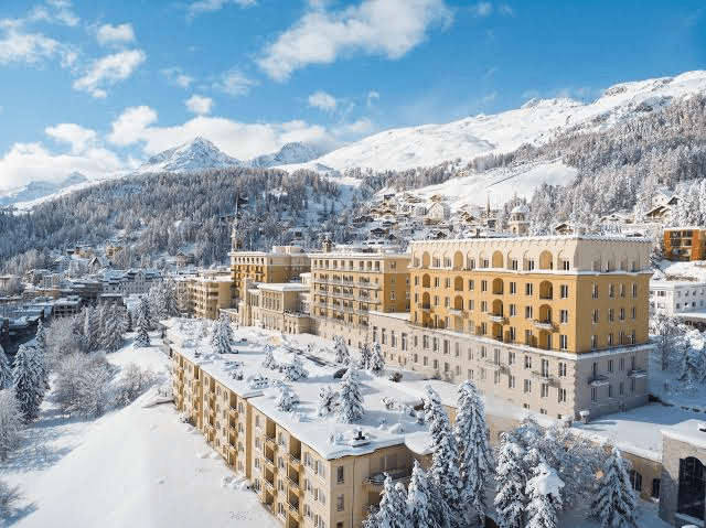 Grand hotel in a snowy village below the mountains
