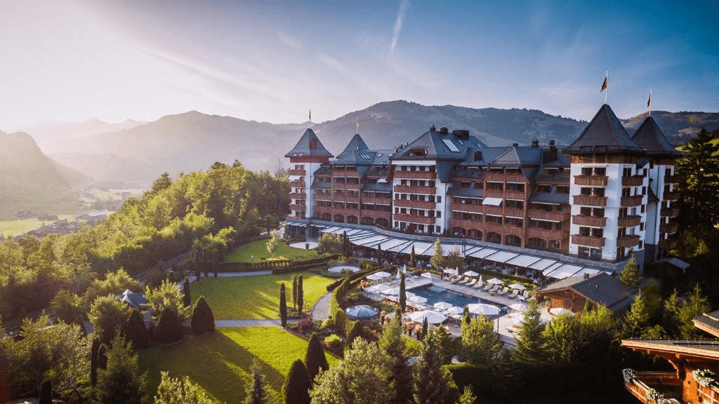 Chalet-style hotel above a valley at sunset