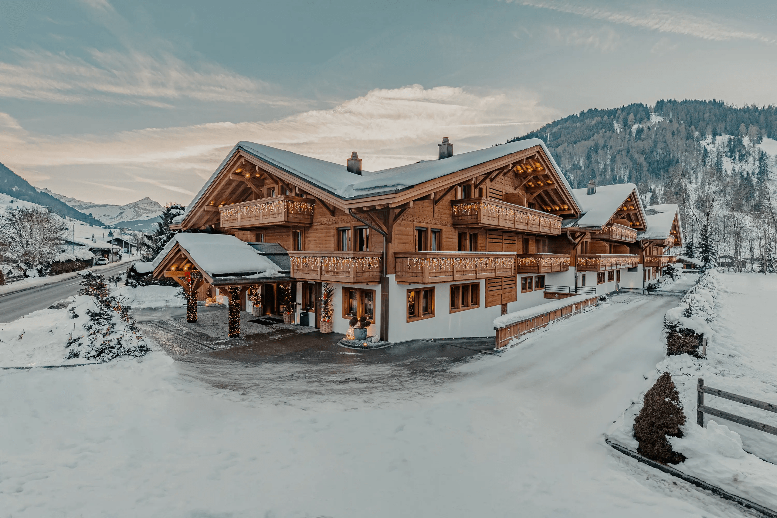 Snow-covered chalet hotel in a winter valley