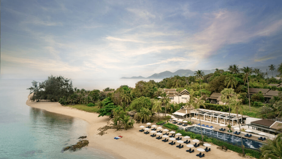 Beachfront resort with loungers along a sandy point