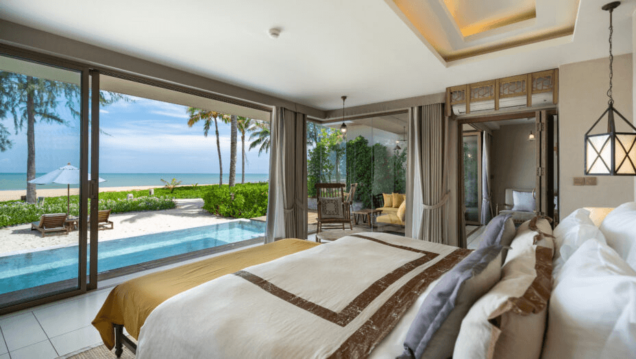 Bedroom opening onto a pool terrace and the sea