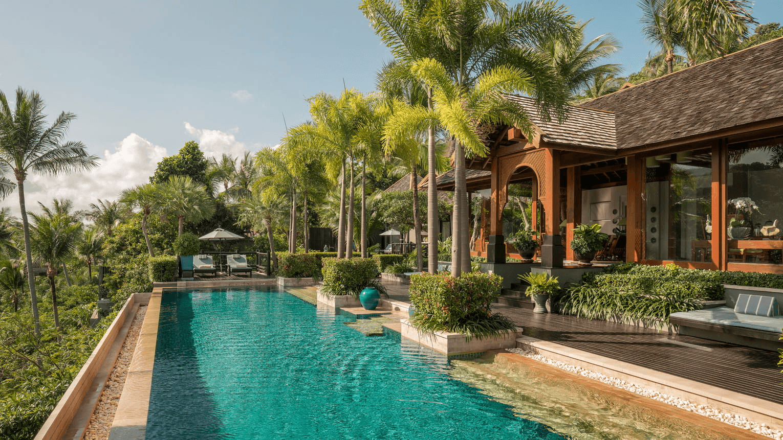 Infinity pool and thatched sala overlooking the sea