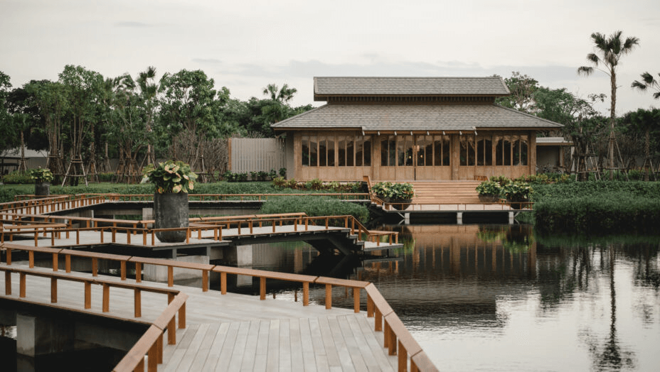 Thai pavilion beside a pond crossed by boardwalks