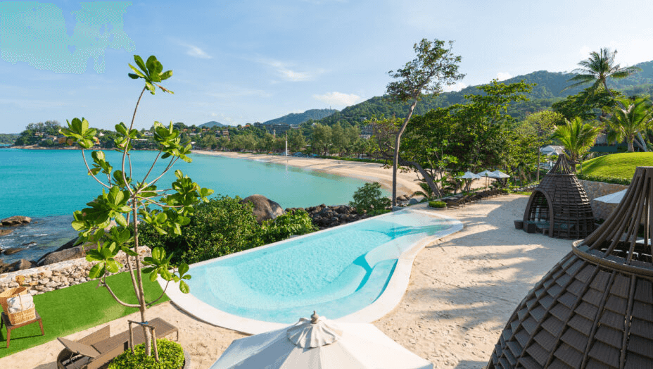 Curved pool above a bay backed by green hills