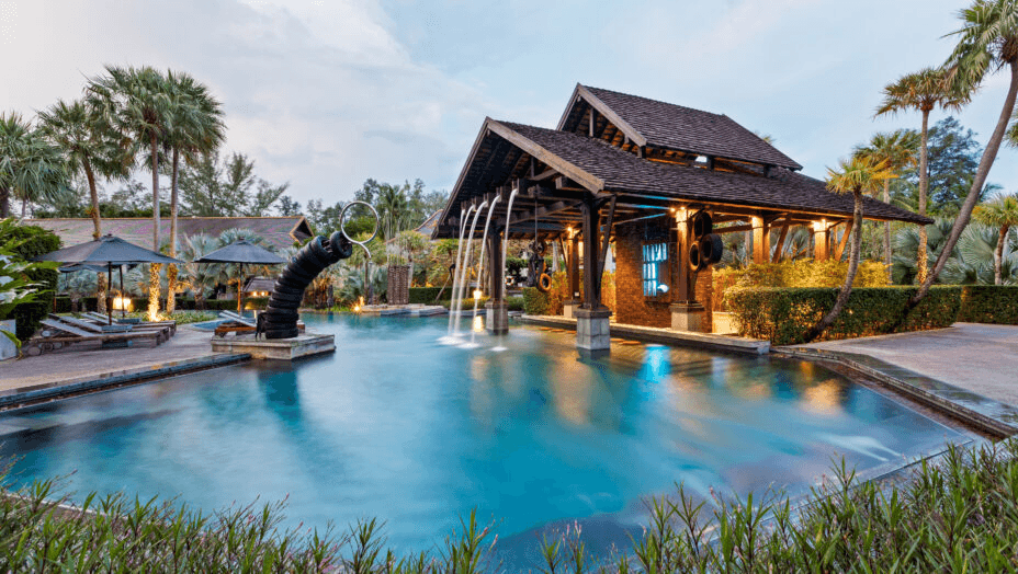 Pool with a fountain in front of a timber pavilion