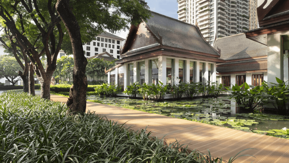 Thai-style pavilion beside a lily pond in a city garden