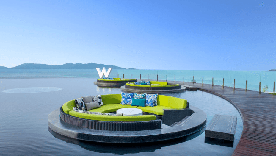 Round lounge pods on an infinity pool facing the sea