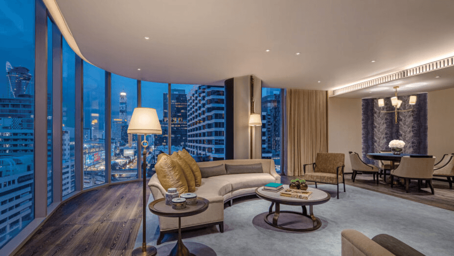 High-floor suite living room with city views at night