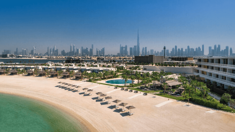 Resort beach and pool with the Dubai skyline beyond