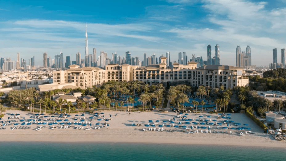 Beachfront resort with the Dubai skyline behind, seen from the air
