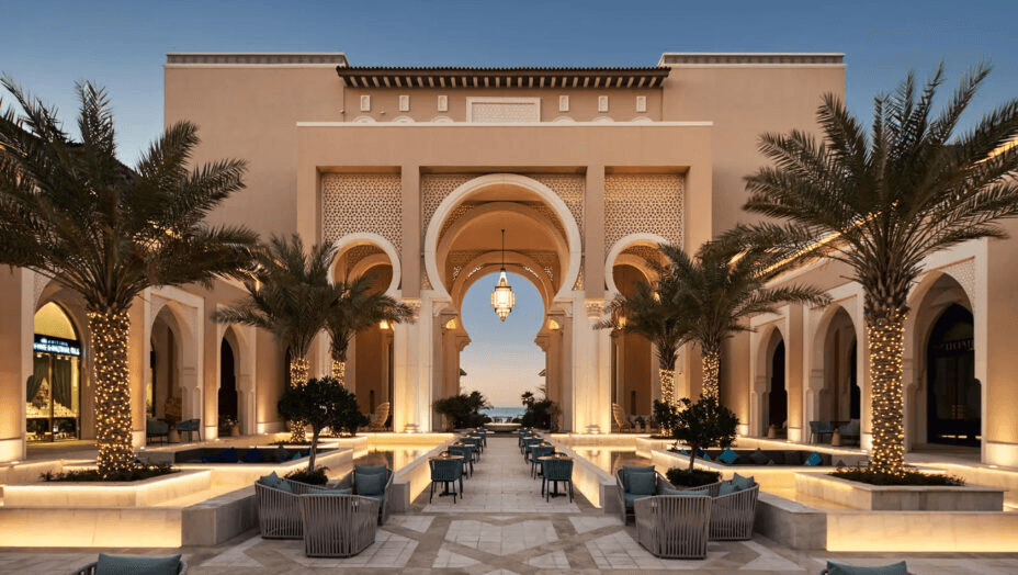 Arched, lantern-lit entrance courtyard at dusk