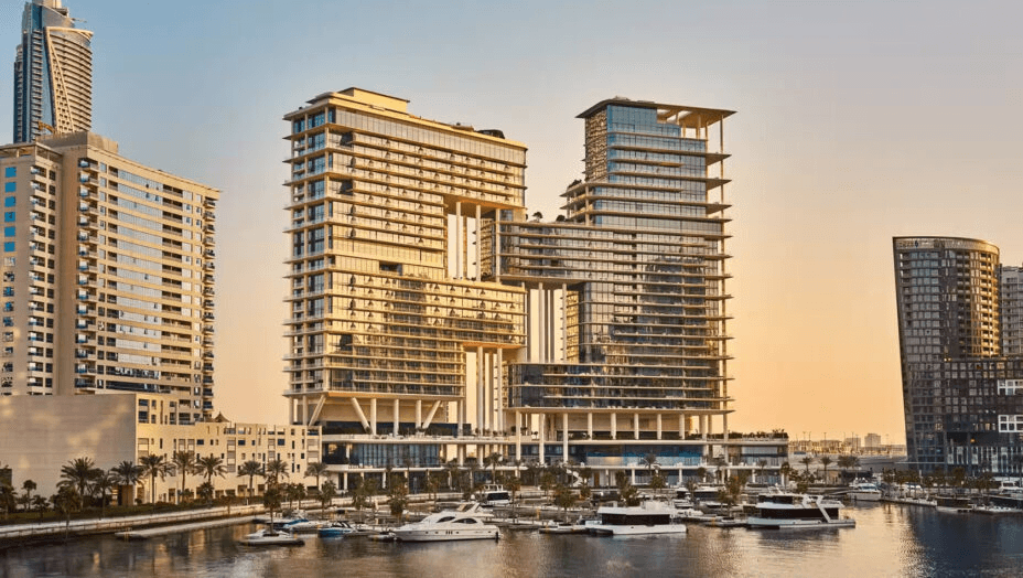 Hotel towers above a marina at sunset